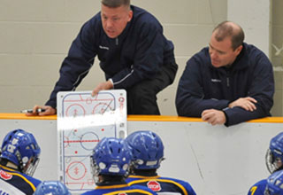 Image of coaches showing drills.